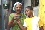 HP Child with grandma looking at a mobile in India